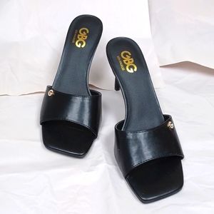 Black heels beautiful no back G insignia fake diamonds on each shoe, all there.